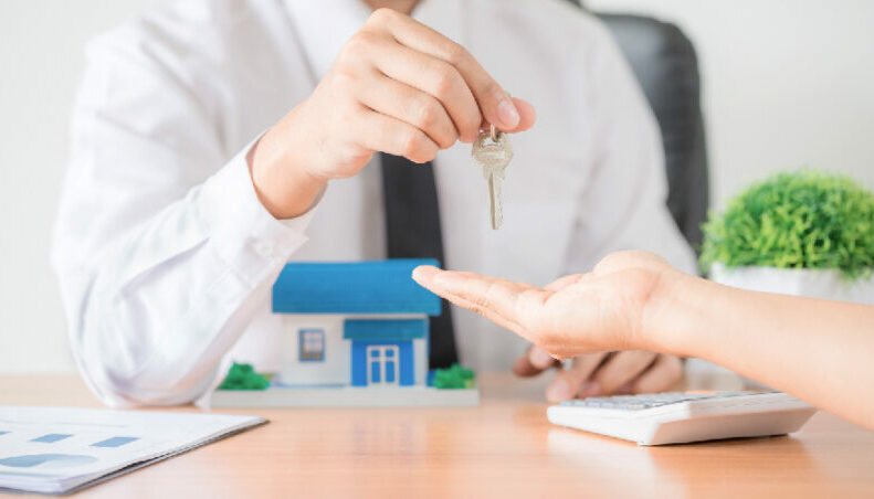 Real estate agent handing over keys to your investment property